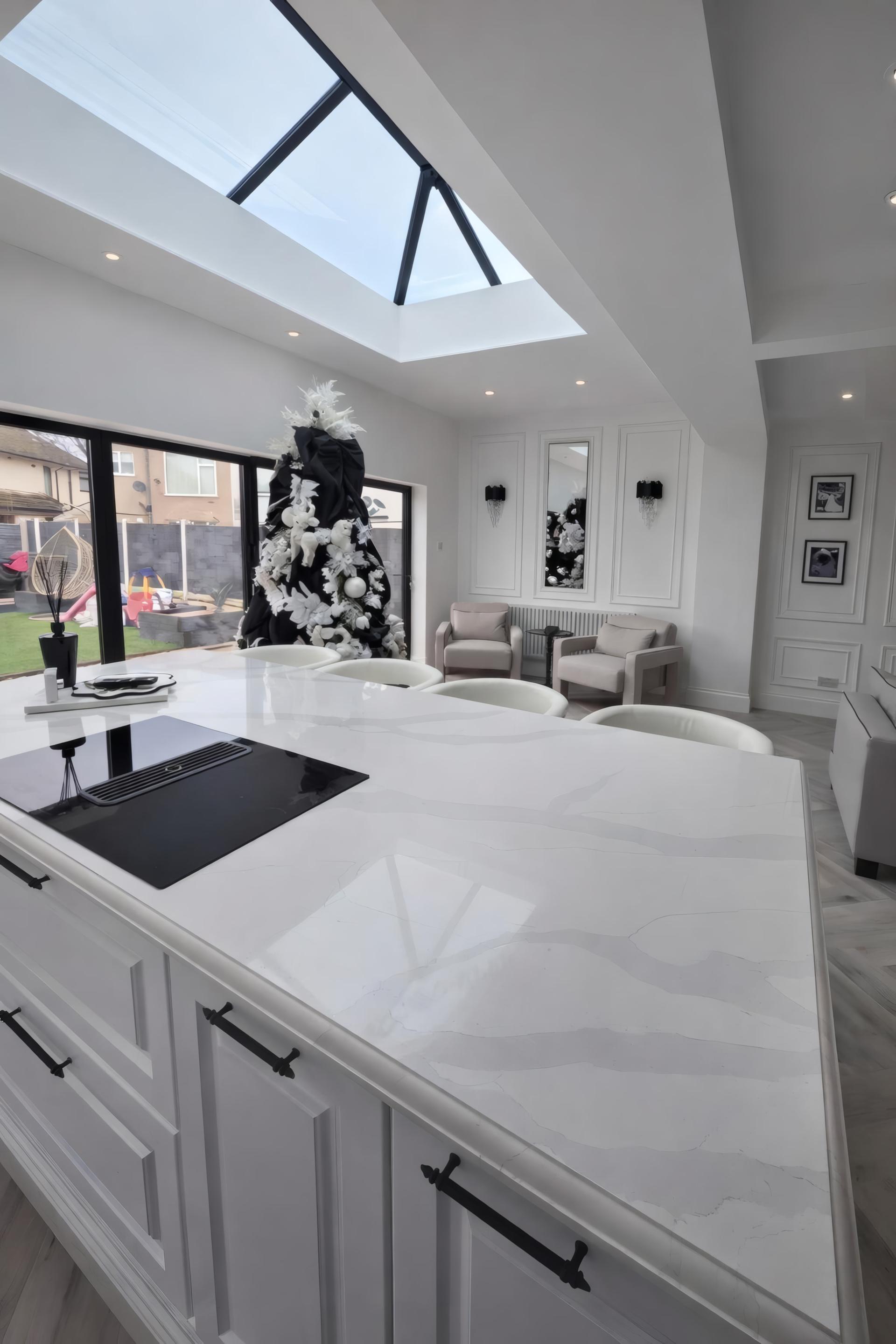 Monochrome open plan kitchen extension with roof lantern in Allerton
