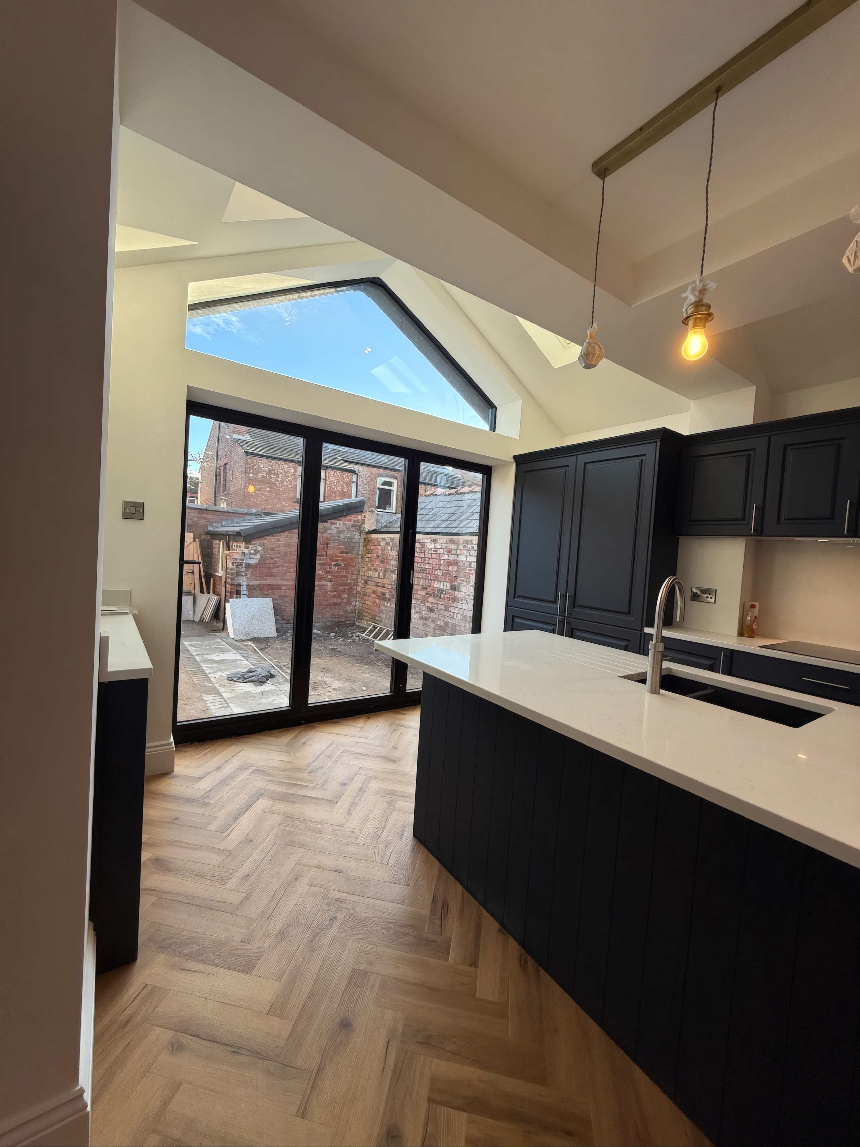Vaulted ceiling house extension with triangular gable glazing and navy shaker kitchen in Liverpool