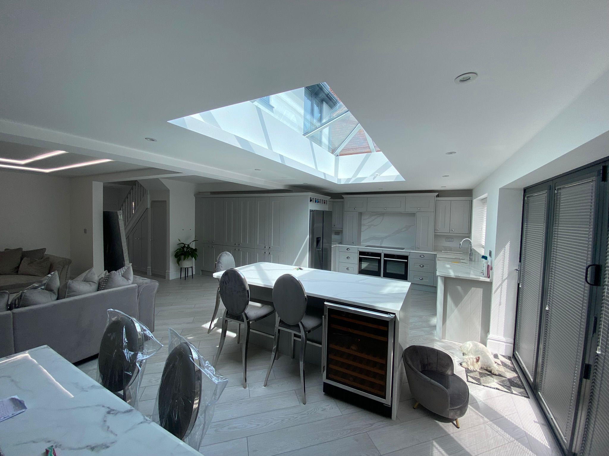 Open plan kitchen extension with glass roof lantern and waterfall island