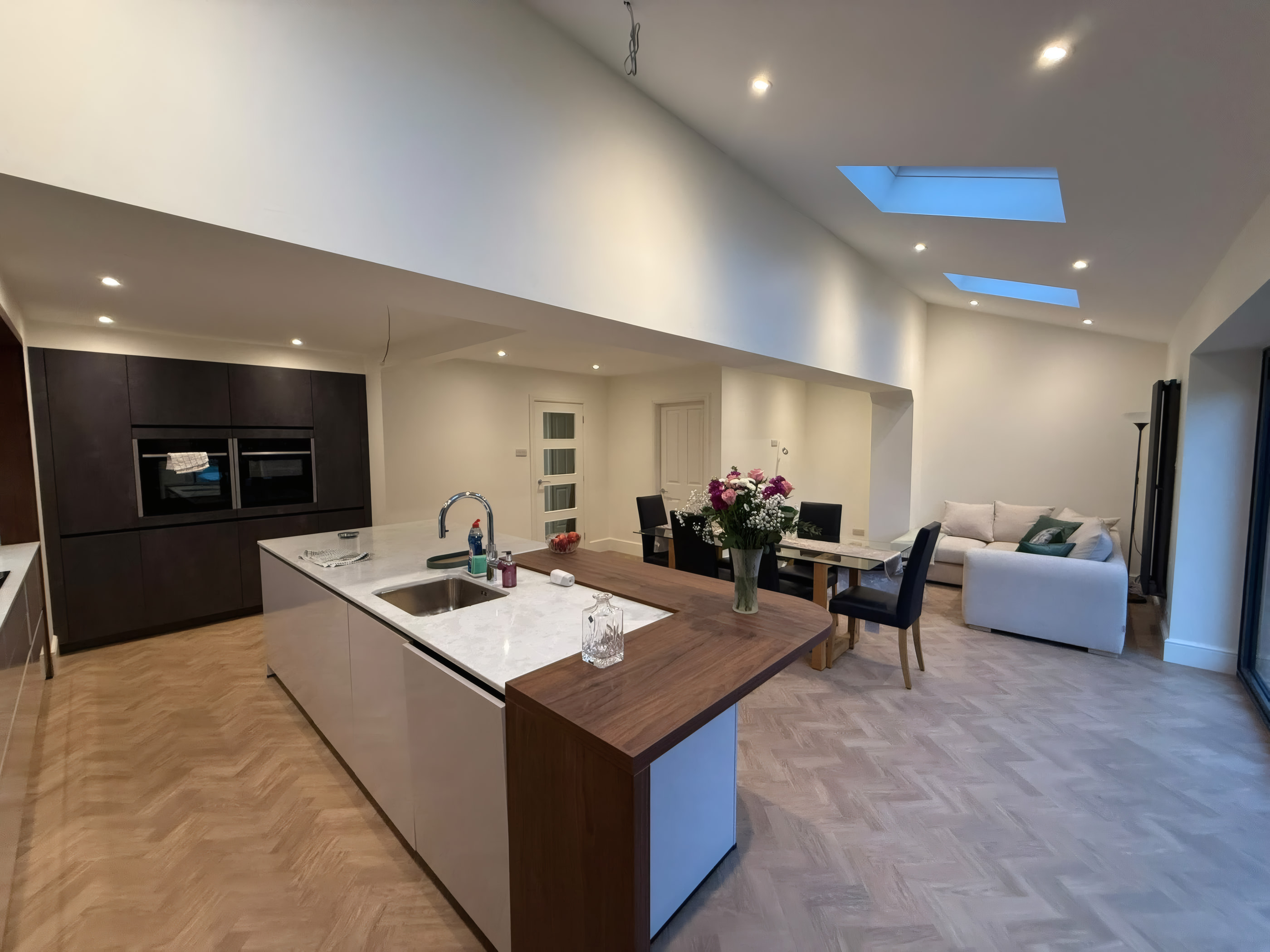 Open plan kitchen extension with walnut breakfast bar and herringbone floor in Liverpool
